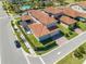 High-angle view of a neighborhood showcasing neat landscaping and red tile roofs at 9406 Mere Pkwy, Orlando, FL 32832