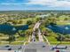 Aerial view of a community with lush landscaping, multiple ponds, and picturesque scenery highlighting an active lifestyle at 9406 Mere Pkwy, Orlando, FL 32832