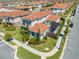 An elevated view of a well-kept neighborhood featuring a home with a Spanish tile roof at 9406 Mere Pkwy, Orlando, FL 32832