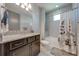 Well-lit bathroom featuring a granite vanity and shower/tub combo with modern fixtures at 9406 Mere Pkwy, Orlando, FL 32832