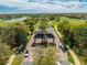 Aerial view of a gated community entrance surrounded by lush landscaping, mature trees, and beautiful scenery at 9406 Mere Pkwy, Orlando, FL 32832