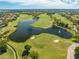 Aerial view of the community golf course showcasing lush fairways, water features, and residential homes at 9406 Mere Pkwy, Orlando, FL 32832