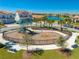 Community playground featuring swings, slides, and benches with a view of the neighborhood pond at 9406 Mere Pkwy, Orlando, FL 32832