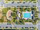 Aerial view of community pool area, playground, palm trees, and parking spaces for neighborhood residents at 9406 Mere Pkwy, Orlando, FL 32832