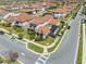 Aerial view of a home's rear exterior featuring a patio with pergola, well-manicured lawn, and a stylish tile roof at 9406 Mere Pkwy, Orlando, FL 32832