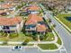 Aerial view of a home's rear exterior featuring a lovely patio and well-manicured lawn with a stylish tile roof at 9406 Mere Pkwy, Orlando, FL 32832