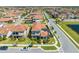 Aerial view of a home's rear exterior featuring a patio and well-manicured lawn with a stylish tile roof at 9406 Mere Pkwy, Orlando, FL 32832