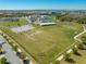 Aerial view of a school featuring athletic fields, playground, and a modern campus design at 9406 Mere Pkwy, Orlando, FL 32832