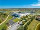 Aerial shot of a school campus with modern buildings, athletic fields, and ample parking in a community setting at 9406 Mere Pkwy, Orlando, FL 32832