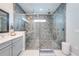 Modern walk-in shower with floor-to-ceiling tiles, and dual shower heads for a luxurious experience at 9406 Mere Pkwy, Orlando, FL 32832