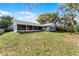 Expansive backyard with a screened-in porch, perfect for outdoor entertaining and relaxation at 950 Sylvia Dr, Deltona, FL 32725