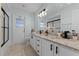 Bright bathroom with double sinks, granite countertops, and modern black fixtures at 950 Sylvia Dr, Deltona, FL 32725