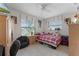 Well-lit bedroom featuring tile flooring, a ceiling fan, and a comfortable bed at 950 Sylvia Dr, Deltona, FL 32725