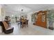 Bright dining room featuring tiled floor, modern light fixture, and wooden table with seating for six at 950 Sylvia Dr, Deltona, FL 32725