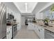 Modern kitchen featuring granite counters, stainless appliances, white cabinets, and an open layout at 950 Sylvia Dr, Deltona, FL 32725