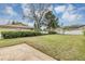 Well-kept backyard featuring lush grass, storage shed, mature trees, and a white fence at 1026 Woodall Dr, Altamonte Springs, FL 32714