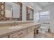 Bathroom showcasing a double vanity, decorative framed mirrors, and a beige countertop with a white sink at 1026 Woodall Dr, Altamonte Springs, FL 32714