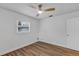 Bedroom showcasing wood-look flooring, white walls, a modern ceiling fan, and natural light from a single window at 1026 Woodall Dr, Altamonte Springs, FL 32714