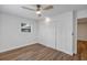 Bedroom showcasing wood-look flooring, white walls, a modern ceiling fan, and built in closet with louvered doors at 1026 Woodall Dr, Altamonte Springs, FL 32714