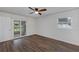 Bedroom with wood-look floors, a ceiling fan, sliding glass door access to the patio, and a window at 1026 Woodall Dr, Altamonte Springs, FL 32714