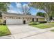 Beautiful home featuring a stone facade, attached garage, and lush green lawn at 1026 Woodall Dr, Altamonte Springs, FL 32714