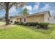 Home with stone accents, a green lawn, mature tree, and a two-car garage at 1026 Woodall Dr, Altamonte Springs, FL 32714