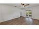 Bright and spacious main bedroom featuring wood-look floors and sliding glass door access to the patio at 1026 Woodall Dr, Altamonte Springs, FL 32714