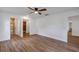 Spacious main bedroom featuring wood-look floors, a ceiling fan, and easy access to the en suite bath and closet at 1026 Woodall Dr, Altamonte Springs, FL 32714