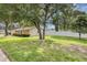 Large grassy front yard featuring a mature tree and a privacy fence at 1026 Woodall Dr, Altamonte Springs, FL 32714