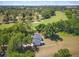 An aerial view of a charming home surrounded by lush greenery and a golf course at 1037 N Virginia Ave, Winter Park, FL 32789