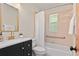 Bathroom with a modern vanity, gold fixtures, and a shower-tub combination with tiled walls at 1037 N Virginia Ave, Winter Park, FL 32789