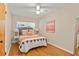 Cozy bedroom features hardwood floors, a decorative bed, and is freshly painted at 1037 N Virginia Ave, Winter Park, FL 32789