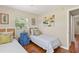 Bright bedroom features hardwood floors, twin beds, and a colorful decor at 1037 N Virginia Ave, Winter Park, FL 32789