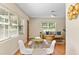 Dining area with hardwood floors, natural light, and view into the living area at 1037 N Virginia Ave, Winter Park, FL 32789