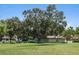 Expansive golf course view with mature trees, clubhouse and open green space at 1037 N Virginia Ave, Winter Park, FL 32789