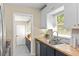 Bright kitchen featuring butcher block countertops, stainless steel appliances, and white upper cabinets at 1037 N Virginia Ave, Winter Park, FL 32789