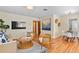 Bright living room with hardwood floors, modern decor, and a glimpse into the dining area at 1037 N Virginia Ave, Winter Park, FL 32789