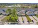 Aerial view of townhomes showcases garages, landscaping, and proximity to a lake at 14143 Ancilla Blvd, Windermere, FL 34786