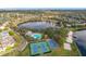 Aerial view of community amenities featuring a lake, pool, tennis, and basketball courts at 14143 Ancilla Blvd, Windermere, FL 34786