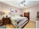 Bedroom with light pink walls, a ceiling fan, and beautiful wood furniture at 14143 Ancilla Blvd, Windermere, FL 34786