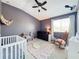 Baby's room has vaulted ceilings, a rocking chair, day bed, and a white crib at 14143 Ancilla Blvd, Windermere, FL 34786