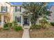 Inviting front exterior with landscaped garden, covered porch, and black door at 14143 Ancilla Blvd, Windermere, FL 34786