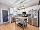 Bright kitchen with stainless steel appliances, white cabinets, and central island at 14143 Ancilla Blvd, Windermere, FL 34786