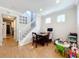 Bright living room with a wood table, staircase, and natural lighting at 14143 Ancilla Blvd, Windermere, FL 34786