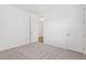 Bright bedroom featuring neutral carpet, white walls, and closet access at 1417 Arbor Hill Dr, Deltona, FL 32725