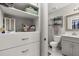 Bathroom and closet showcasing custom shelving, drawers, and a walk-in shower at 14203 Avenue Of The Grvs, Winter Garden, FL 34787