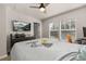 Bright bedroom featuring a ceiling fan, large TV, and a window providing ample natural light at 14203 Avenue Of The Grvs, Winter Garden, FL 34787