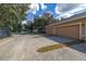 Long driveway with a two-car garage and meticulously maintained landscaping at 14203 Avenue Of The Grvs, Winter Garden, FL 34787