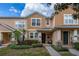 Charming townhome featuring manicured landscaping, a covered entry, and a welcoming facade at 14203 Avenue Of The Grvs, Winter Garden, FL 34787