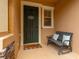 A covered entryway features a charming welcome mat and bench with accent pillows at 14203 Avenue Of The Grvs, Winter Garden, FL 34787